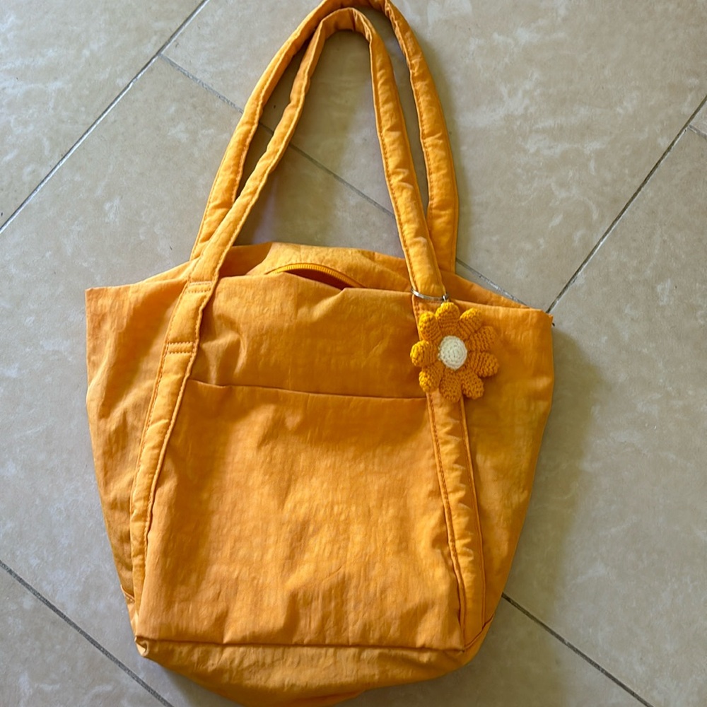 BAGGU orange bag with crochet flower keychain